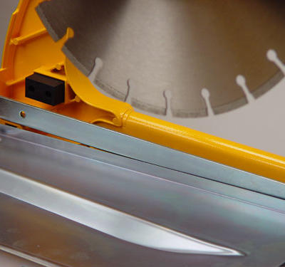  A steel plate located beneath the cutting head deflects dust generated from the cutting action away from the operator.